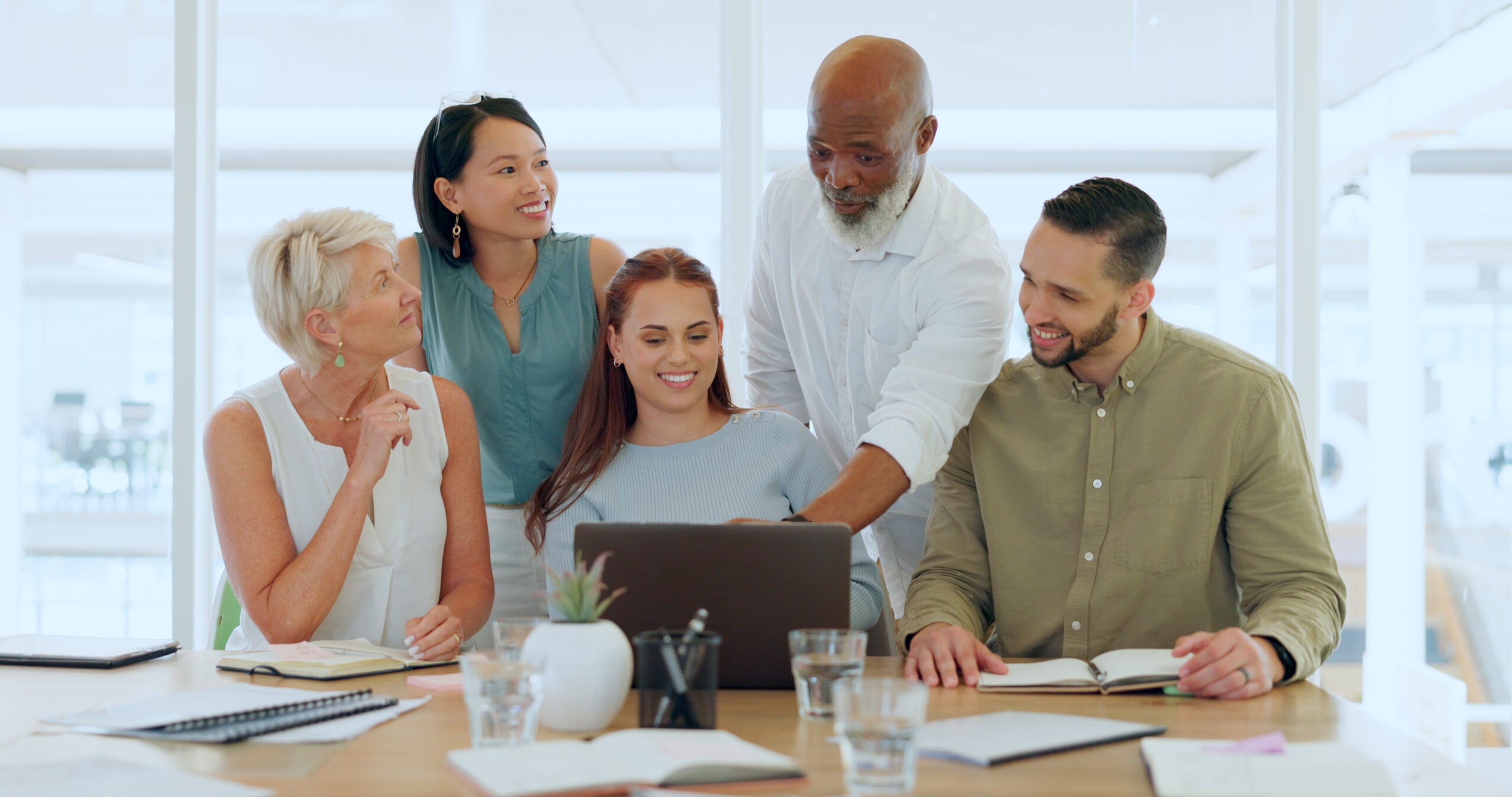 Teamwork at laptop presentation in office of marketing, advertising and design company.