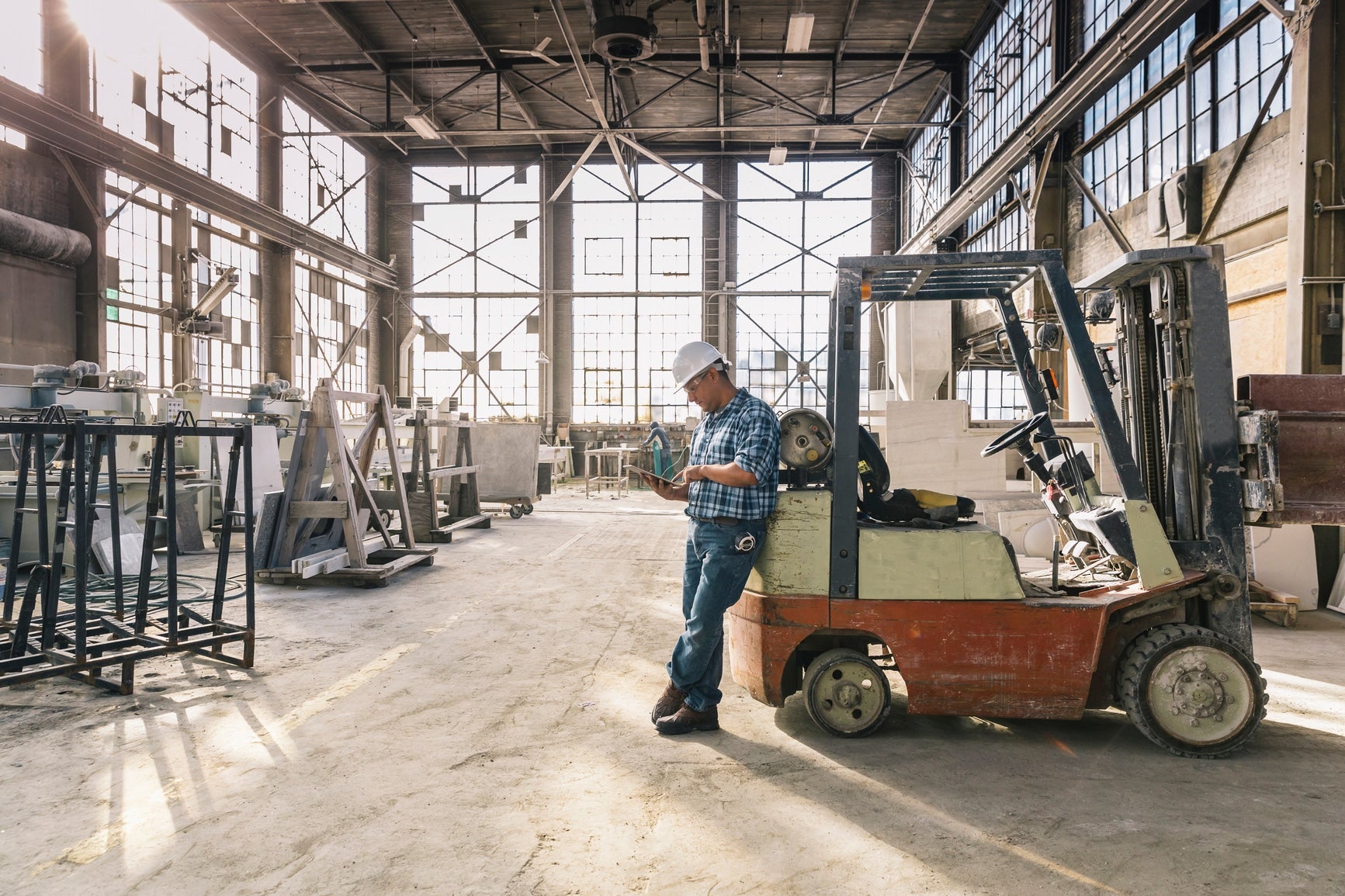 Blue Collar Worker Using Computer Tablet At Work